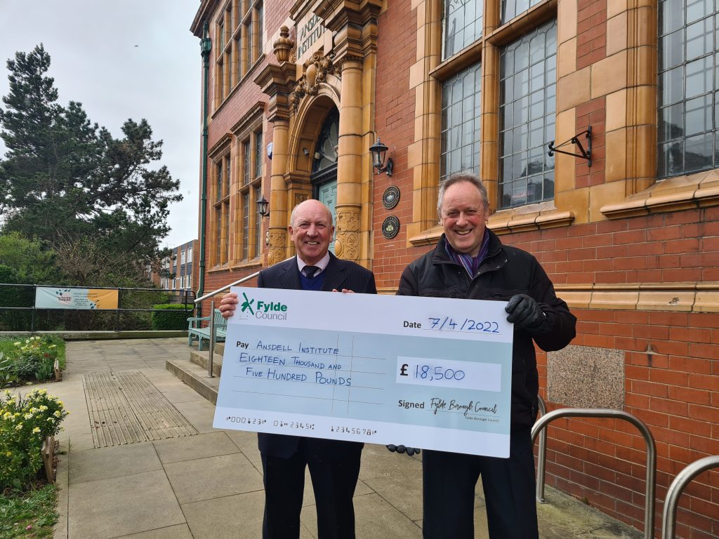 Cllr Roger Small [R], Deputy Leader of Fylde Council, presents cheque to Cllr Ben Aitken, Chair of Friends of Ansdell Institute.